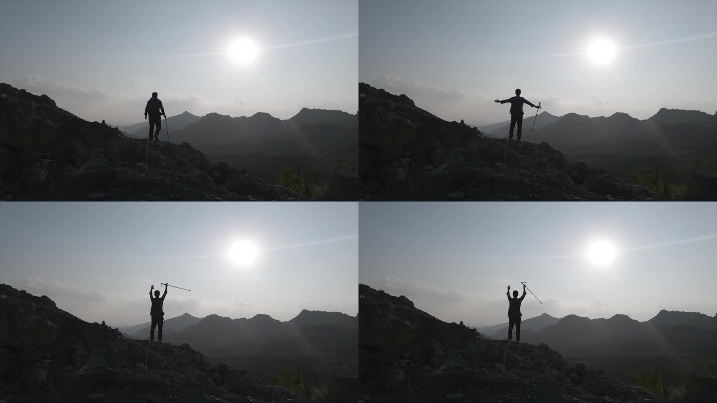 登山者站在山顶举手呐喊向往自由山顶呐喊