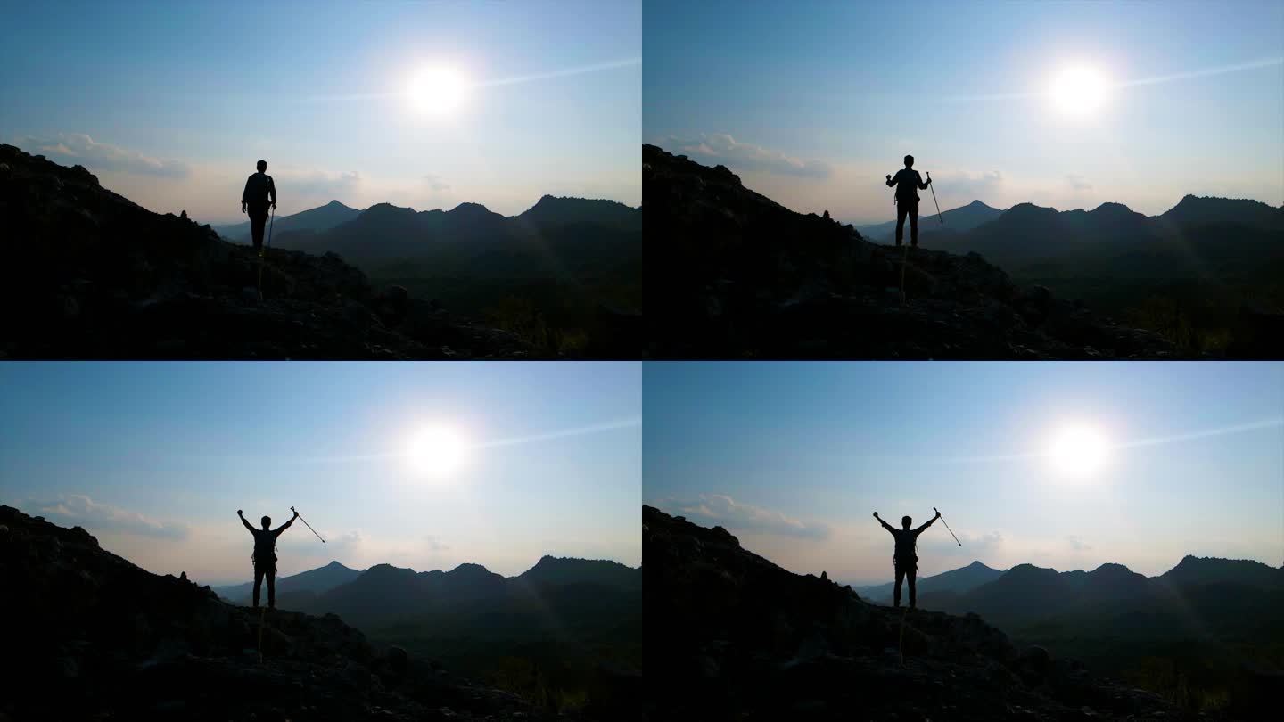 登山者站在山顶举手呐喊向往自由山顶呐喊