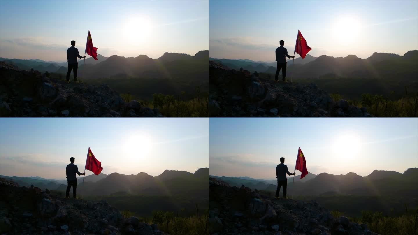手持国旗站在山顶眺望远方爱国素材红旗飘扬