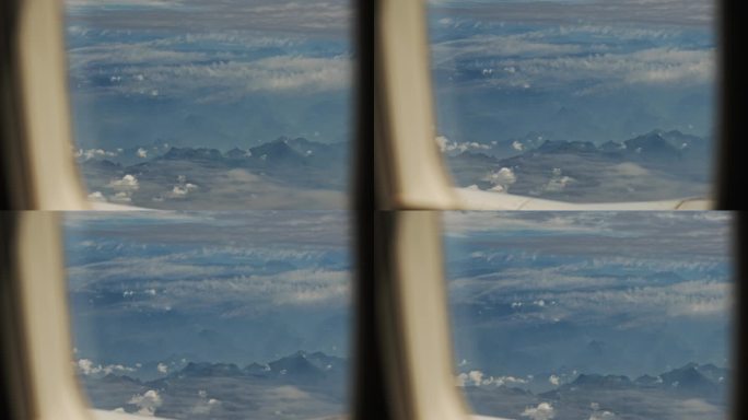 从飞机窗户看窗外崇山峻岭水墨画云层山峰