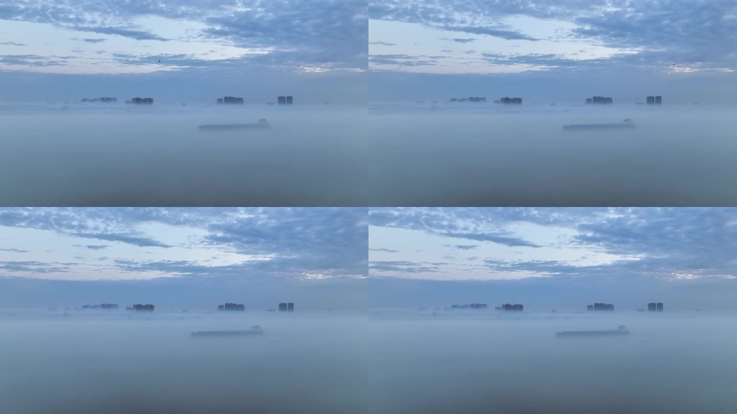 航拍江雾中航行的货轮