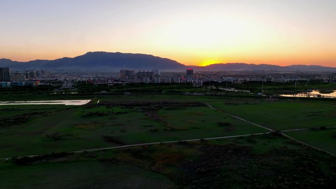 航拍夕阳下的宁夏石嘴山市惠农区城市风光