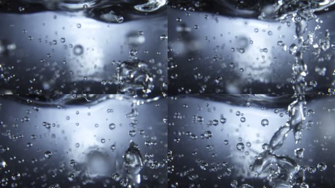 流体粒子杯中水中气泡上升倒水视频素材