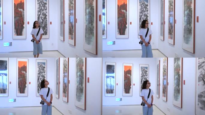 4K升格实拍在艺术馆参观欣赏画展的女孩