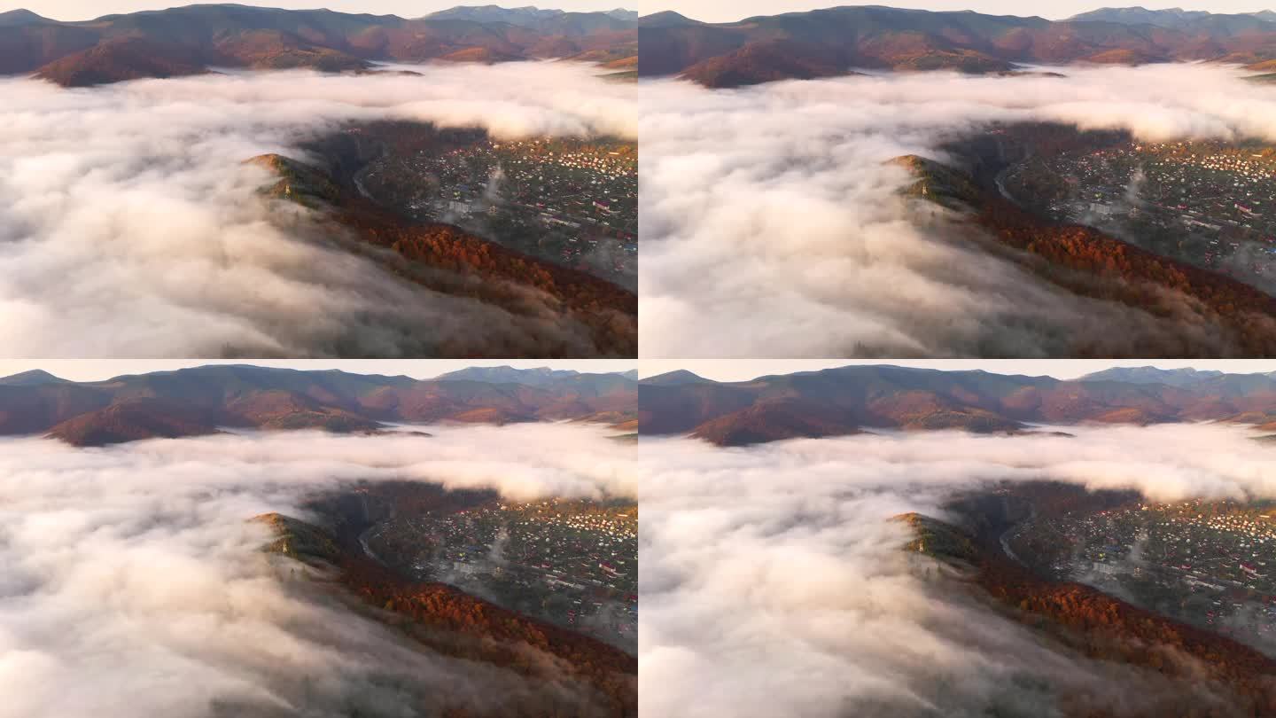 无人机在翻过山脊的雾中飞行.以，无人驾驶视频拍摄.