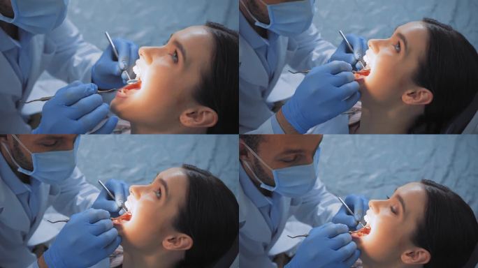 医生在牙科诊所与病人共事时使用牙科器械 