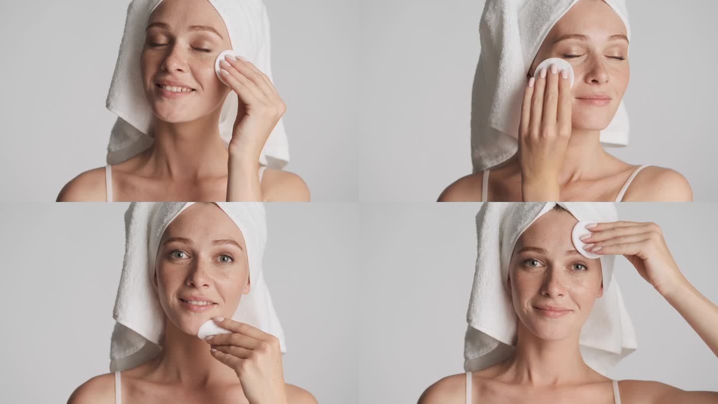 漂亮的姑娘，头戴毛巾，用棉质海绵在灰蒙蒙的背景下洗脸