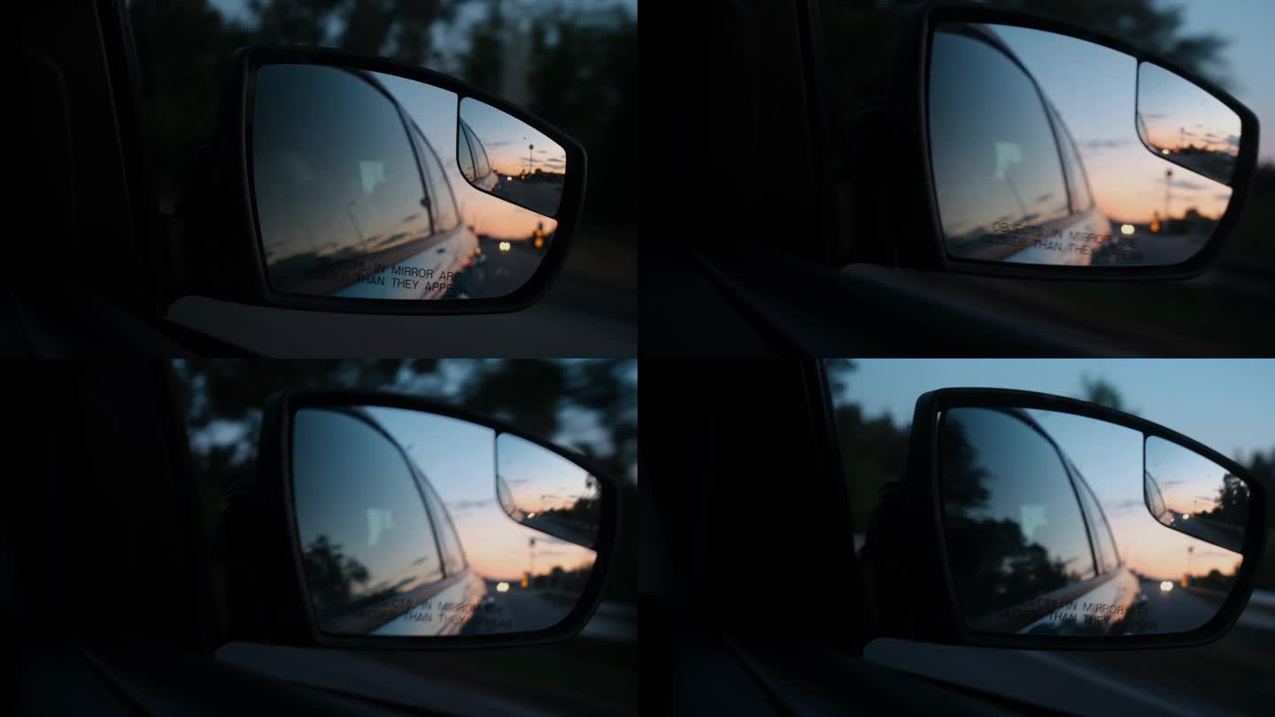 汽车后视镜中日落的倒影.开车旅行。汽车后视镜.