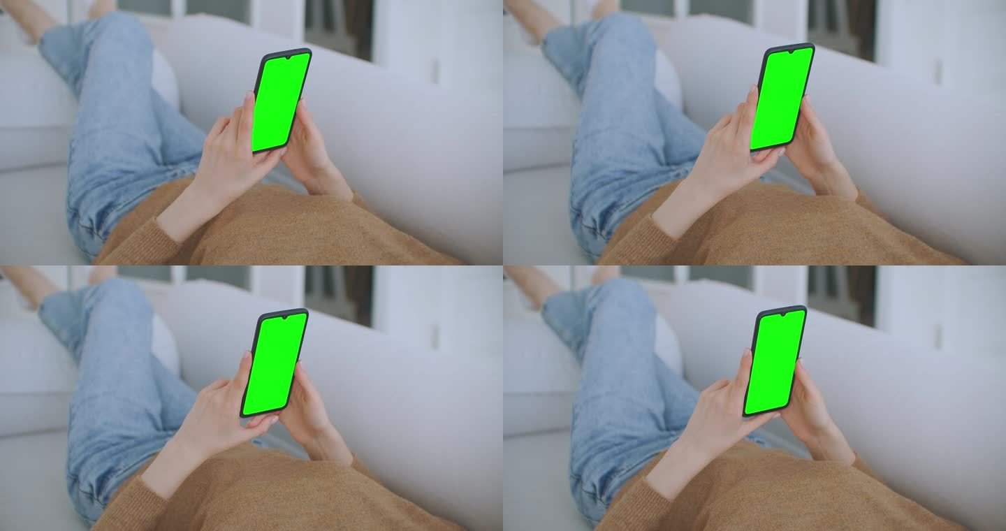小女孩在晚上拿着装有绿色屏风的智能手机。智能手机在手，静态镜头与小手移动。屏幕上跟踪移动的指示数
