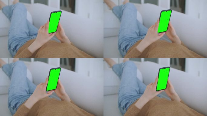 小女孩在晚上拿着装有绿色屏风的智能手机。智能手机在手，静态镜头与小手移动。屏幕上跟踪移动的指示数