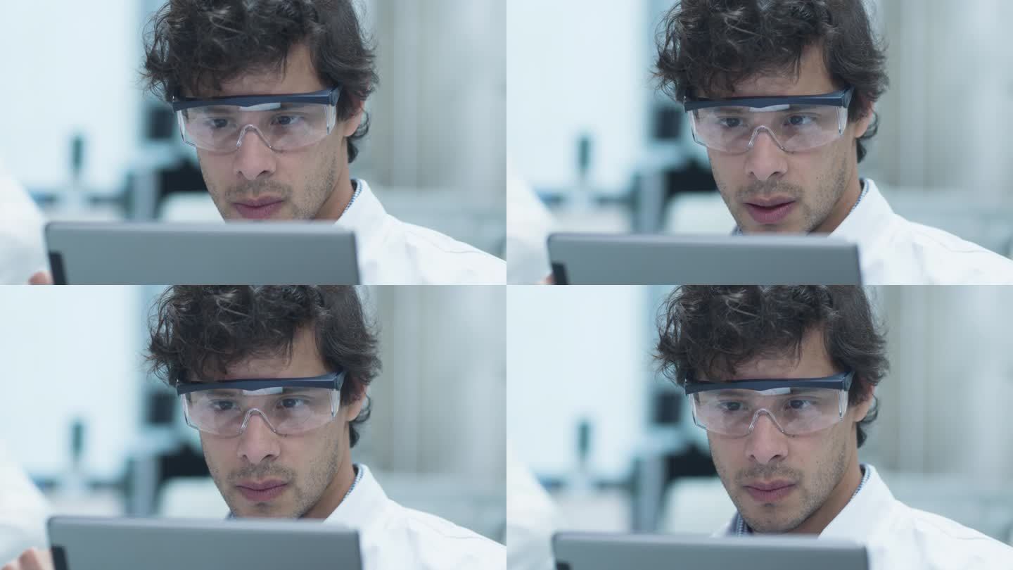 拉丁族裔科学家在实验室中使用平板电脑的安全眼镜。