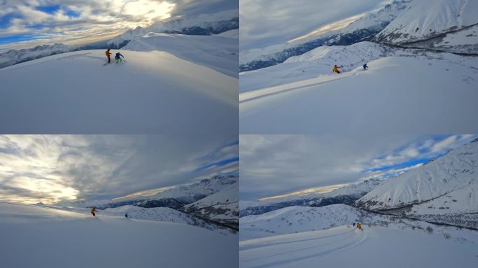 FPV无人机sot跟随滑雪者和滑雪板骑行雕刻粉末雪谷，两名穿着鲜艳服装的极端女运动员在雪山上骑行的电