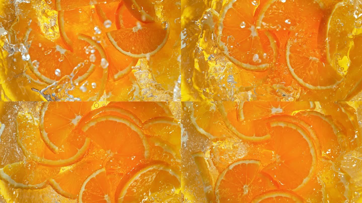 超级慢镜头新鲜橙片坠落进水漩涡1000 fps。用高速电影摄影机拍摄。