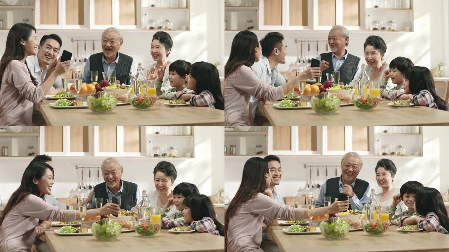 三代亚洲人快乐的家庭，一边在家里吃饭一边享受时光