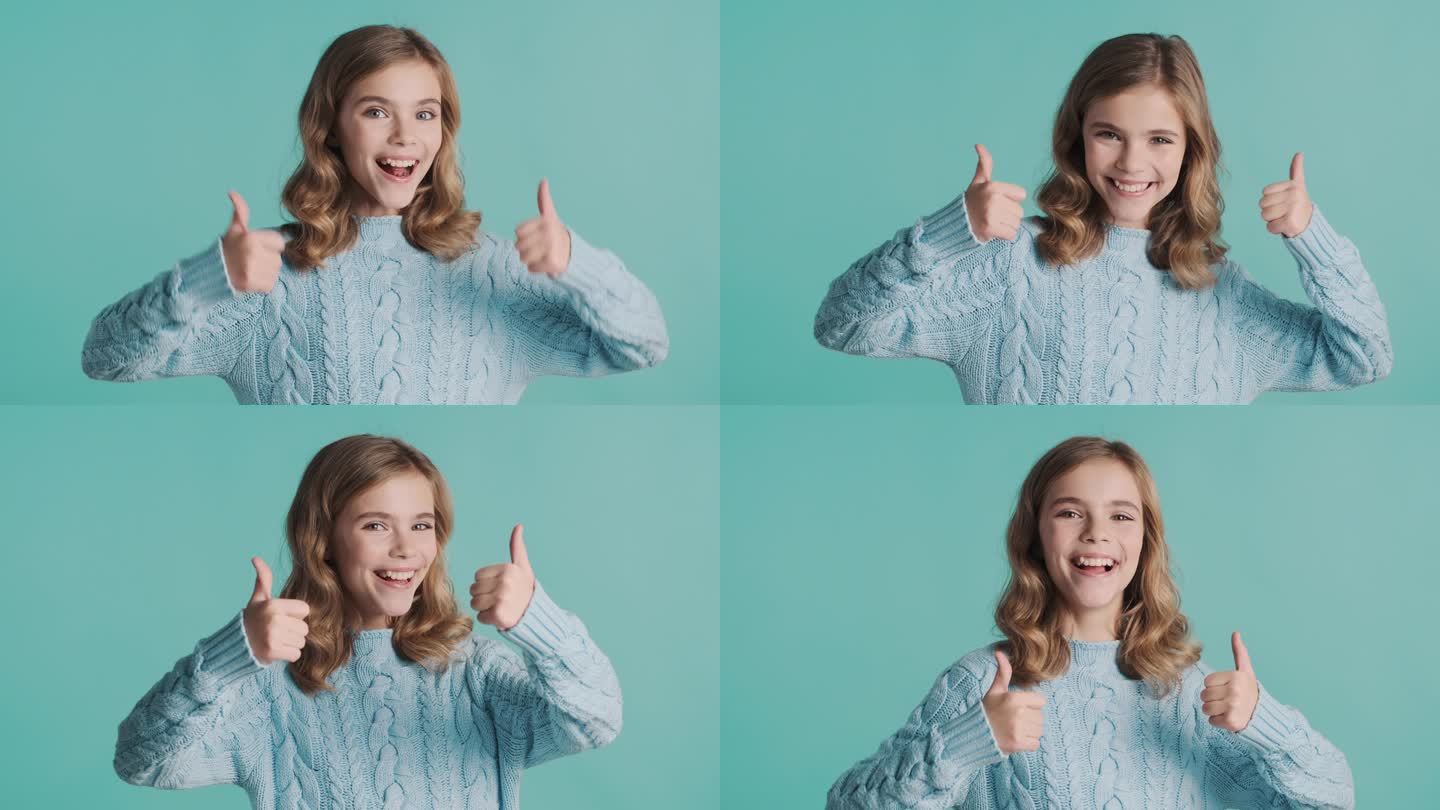 漂亮的金发少女在镜头前竖起大拇指，带着蓝色背景的微笑。身体语言概念