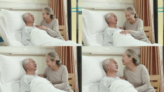 亚洲老年妇女在医院拜访丈夫，与丈夫聊天，亲吻额头