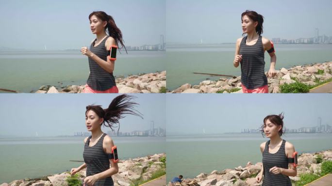 年轻的亚洲女人在海滨公园跑步