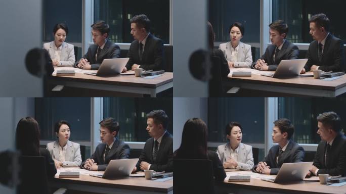 由亚洲商人组成的团队工作到很晚的男人和女人晚上在办公室开会
