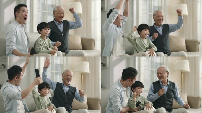 亚洲男孩的父亲和祖父在家里一起观看电视转播的足球比赛，庆祝一个进球