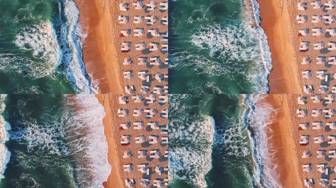 海洋海滩海岸的航拍视频，遮阳伞和躺椅，巨浪冲刷海沙