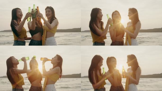 一群亚洲少女在沙滩上聚会庆祝，晚上日落时，朋友们在沙滩上愉快地喝啤酒。户外旅游假期假期夏季概念。慢动