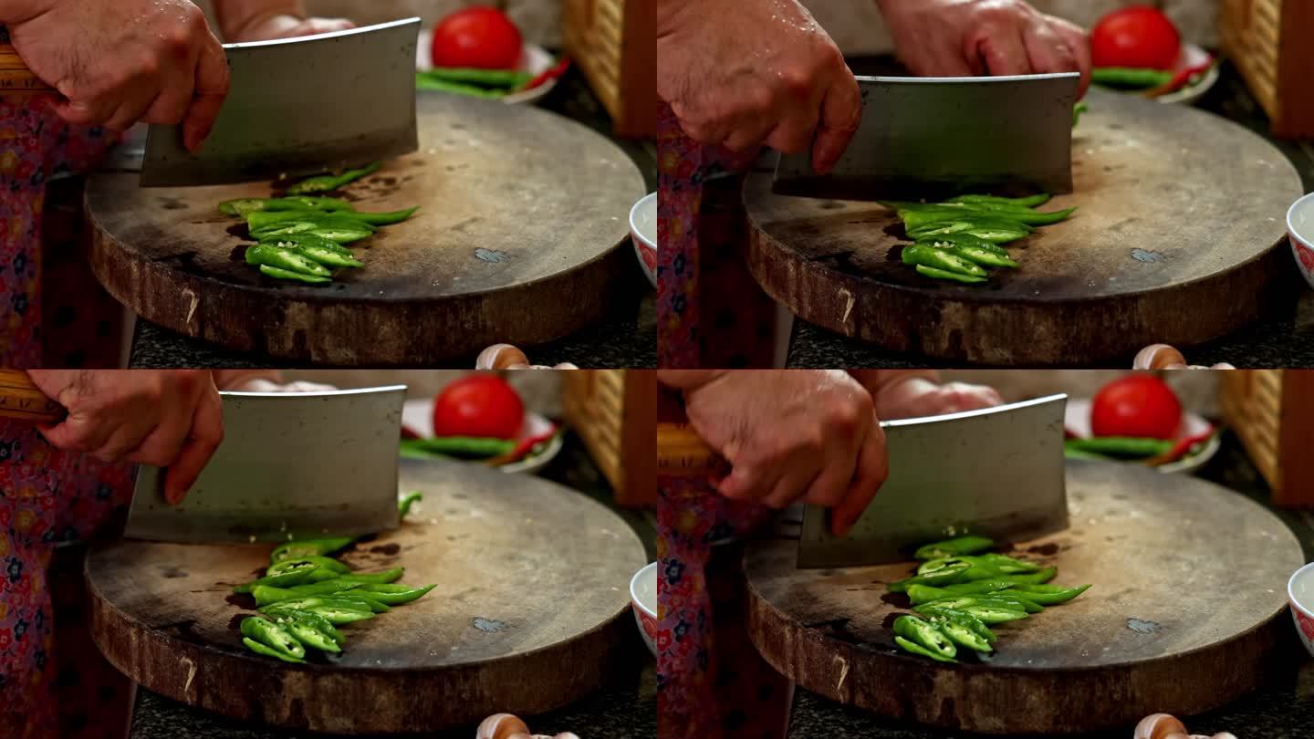 手握菜刀在案板上切菜