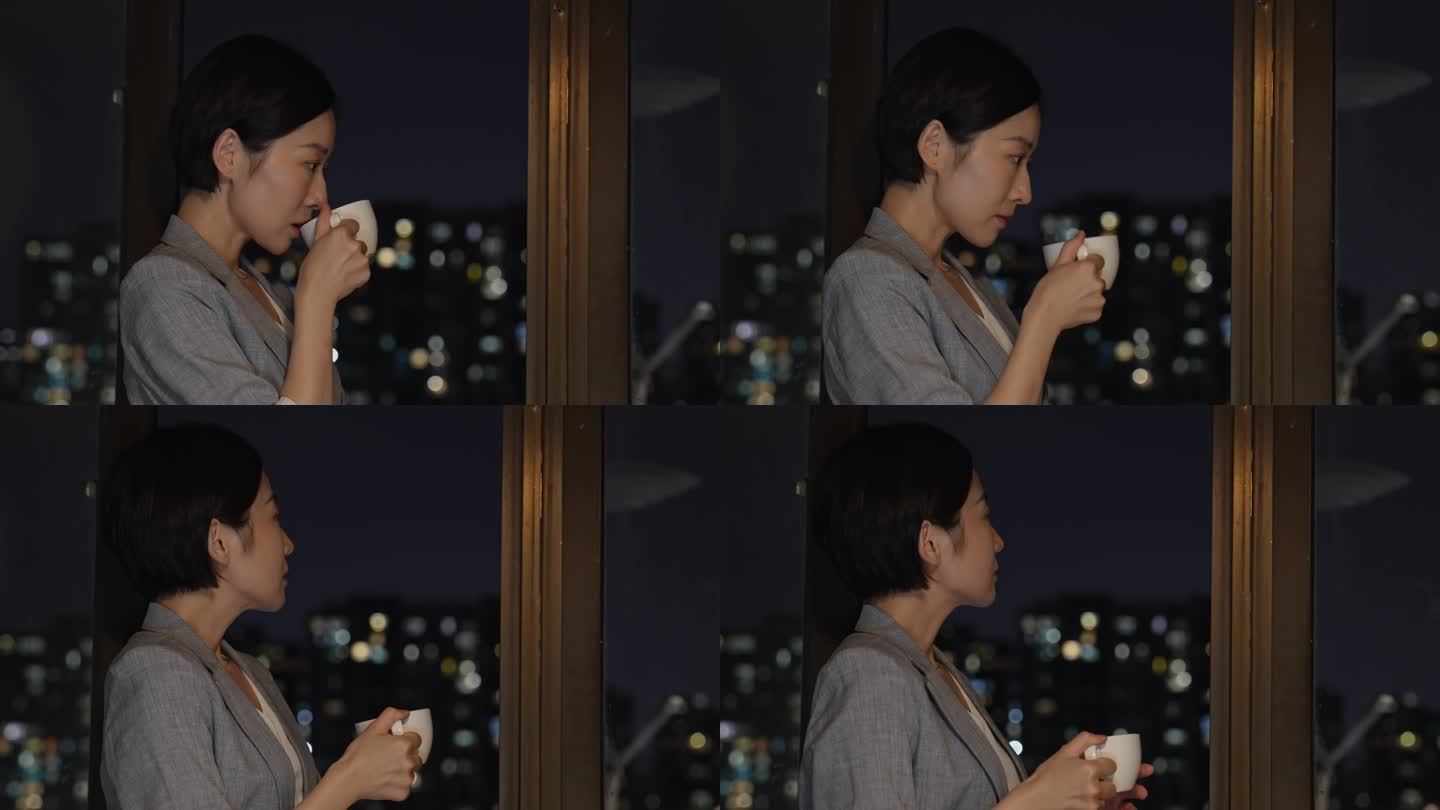 都市女性喝咖啡看着城市夜景