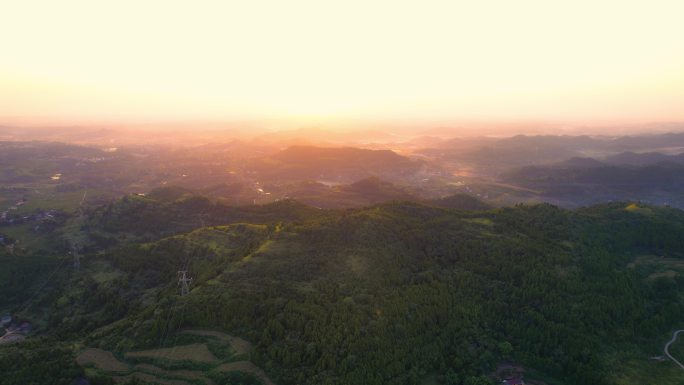 航拍山谷霞光下农村