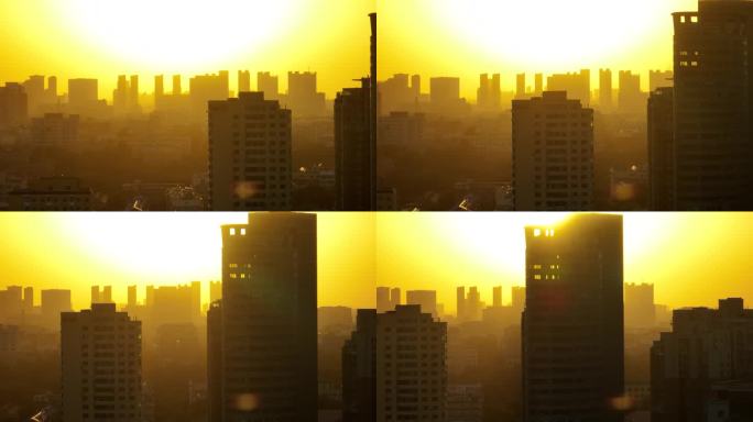 夕阳下的城市建筑剪影航拍