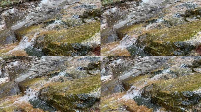 山间小溪在石头间流淌着水花