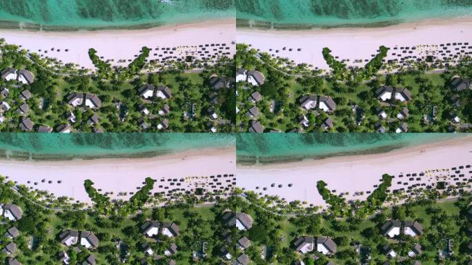 俯拍海边沙滩椰树林度假别墅