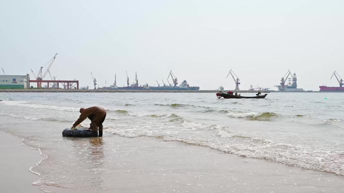 海边码头沙滩上准备潜水捕鱼的渔民