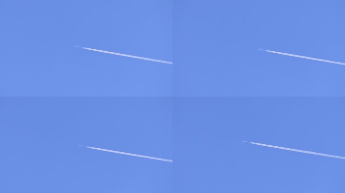 飞机在蓝色天空留下白色机尾云