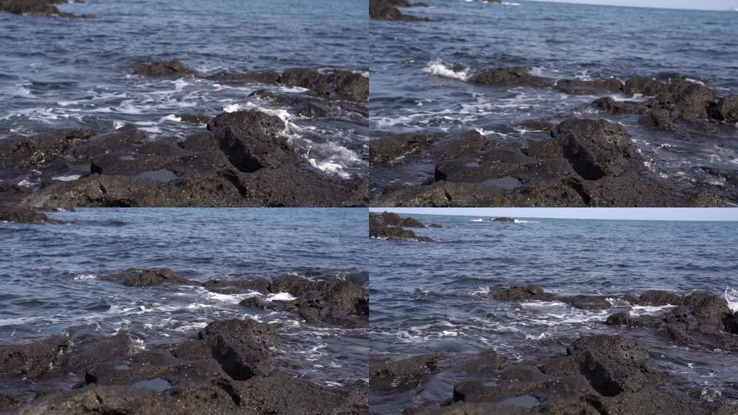济州岛海边黑礁石海浪