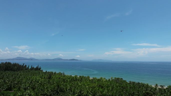 航拍三亚海棠湾蓝天白云直升机沿海岸线飞行