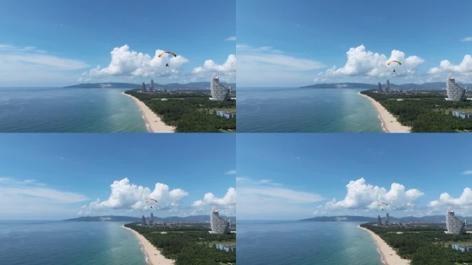 航拍三亚海棠湾蓝天白云动力伞沿海岸线飞行