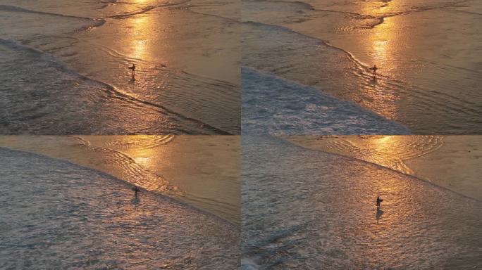 夕阳下抱着冲浪板的少年剪影