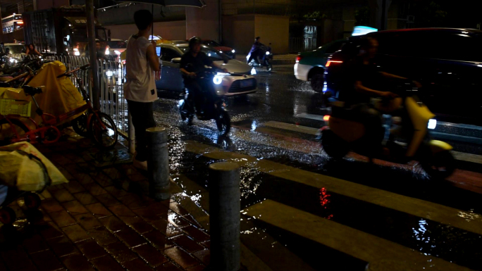 大雨滂沱，城市夜雨，车人雨中行走