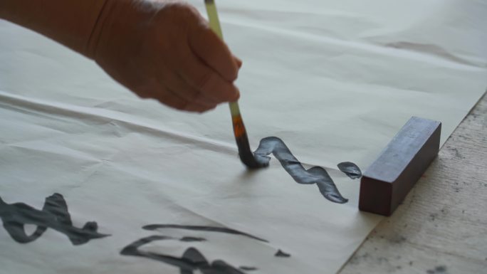 一位著名的中国书法家在用毛笔书写作品