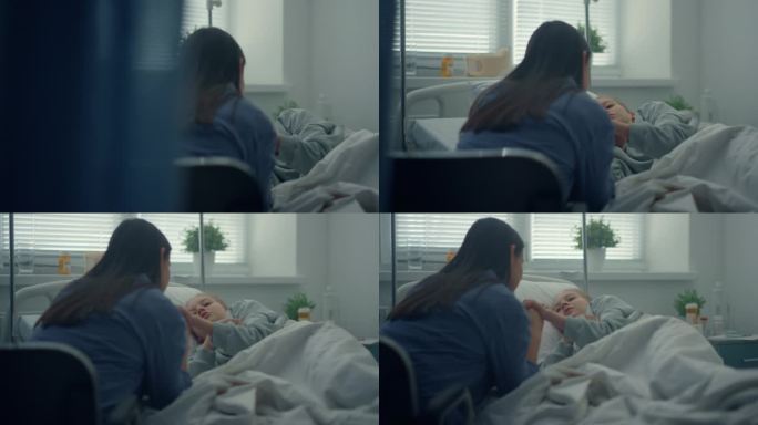 躺在医院病床上的小女孩支持来访的妇女牵着孩子的手。