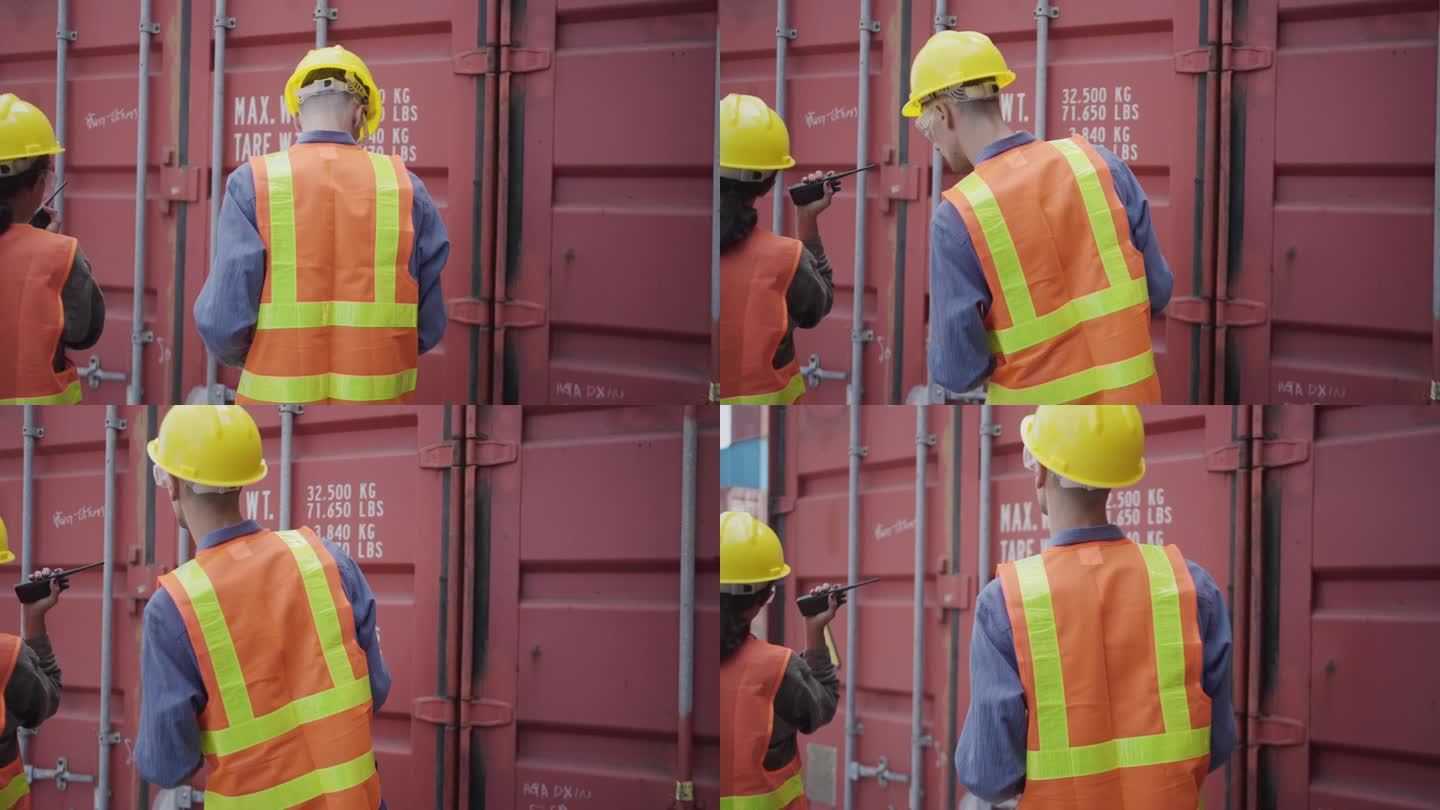 码头工人在商业码头检查集装箱。