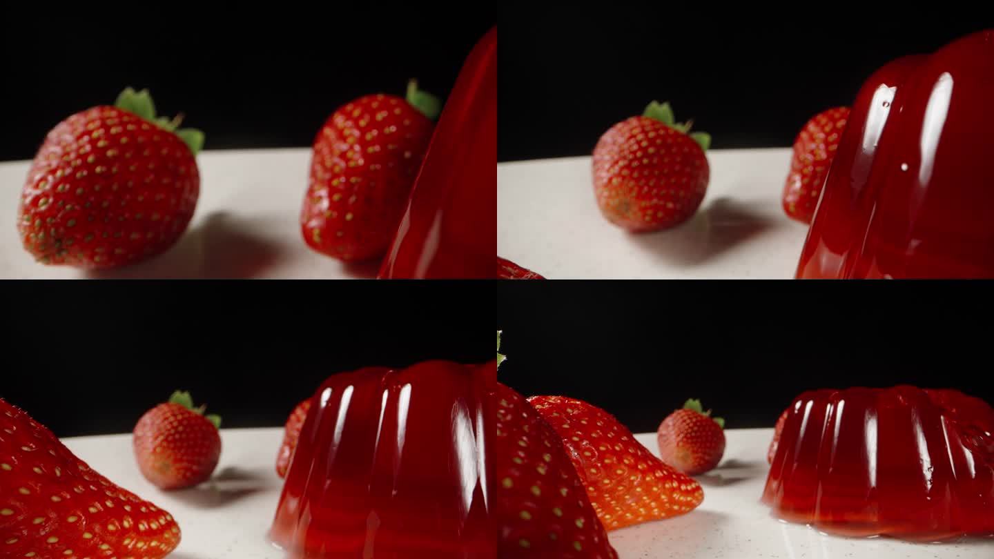 白色盘子里放着草莓和红果冻。黑色背景。多莉滑块极端特写。