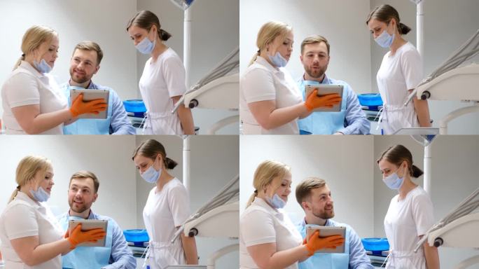一位英俊的年轻病人在两位女牙医的陪伴下看着苹果智能手机