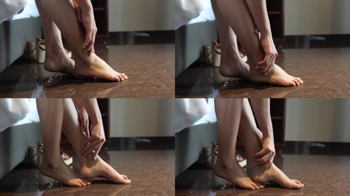 由于脚踝疼痛，女性手触摸脚踝的剪辑镜头