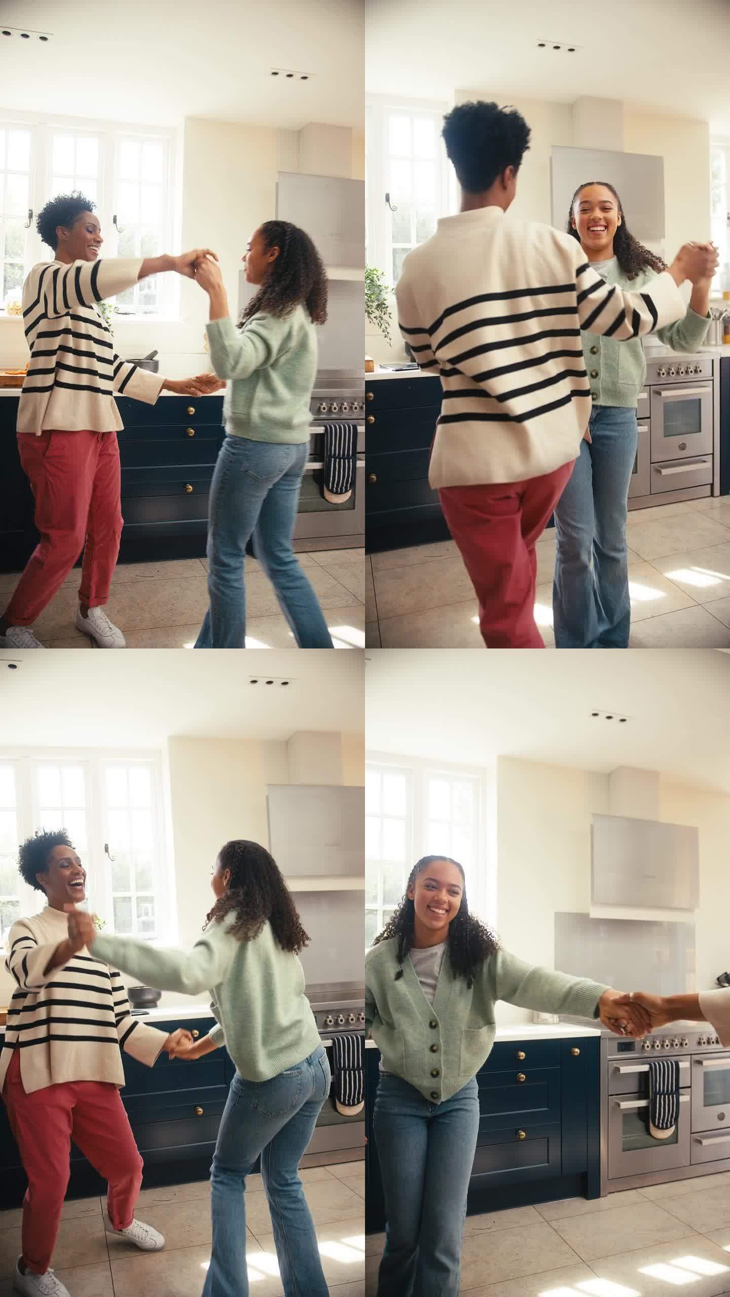 母亲和十几岁的女儿在家里的厨房里一起跳舞的垂直视频