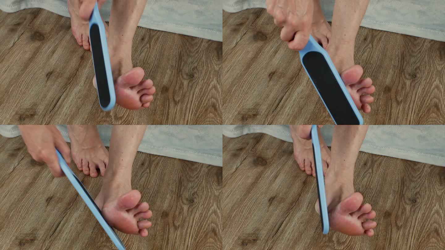 一个女人用一个双面磨脚器磨她的脚后跟。雌性用磨碎器清洗脚，去除脚跟上的老茧。修脚工具。足部护理。女性