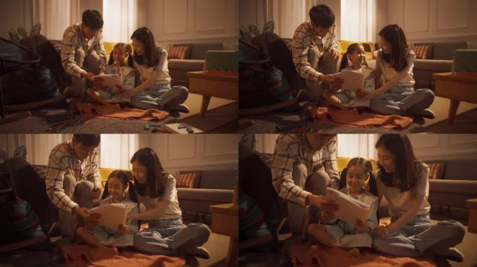完美的小女儿向快乐的爸爸妈妈展示她的画，让他们感到骄傲。才华横溢的韩国女孩在真实的公寓里与父母在家练