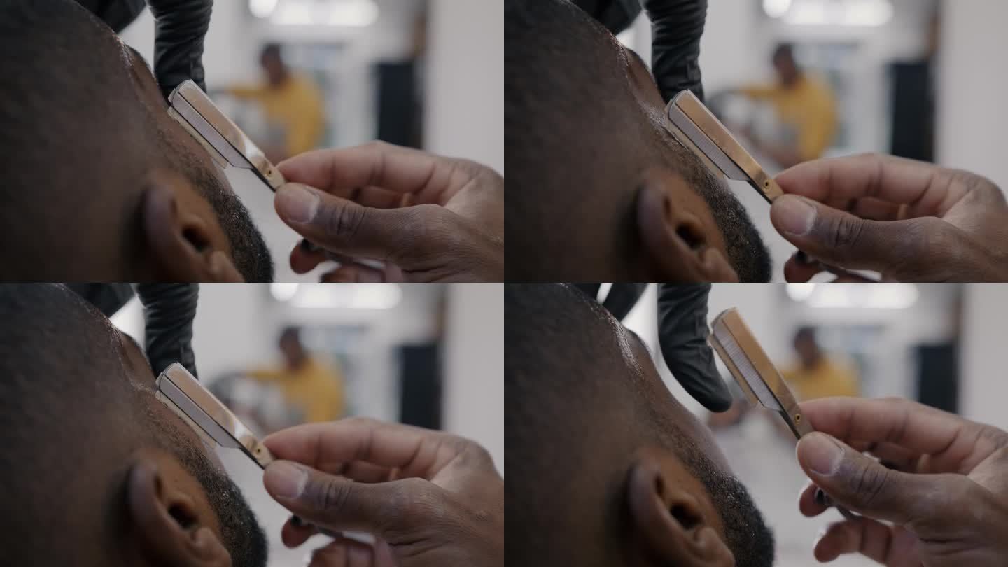 理发师在理发店照顾顾客时，用锋利刀片剃须的手特写
