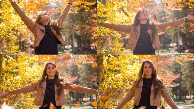 快乐的年轻女子在色彩斑斓的森林里享受秋天