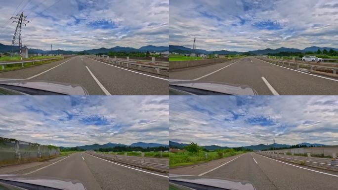 从一辆行驶在高速公路上的汽车上看到美丽的蓝天和白云